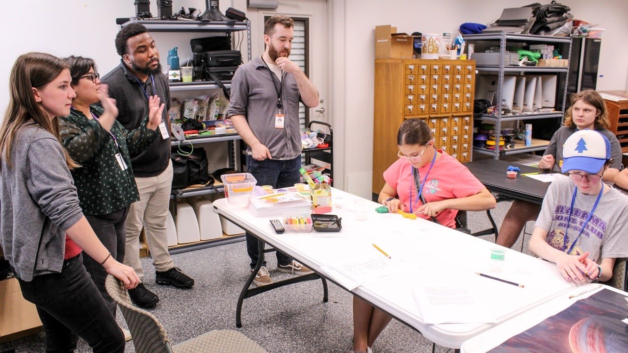 Library staff helping teens with a hands-on activity in the Collaboratory at FLPL